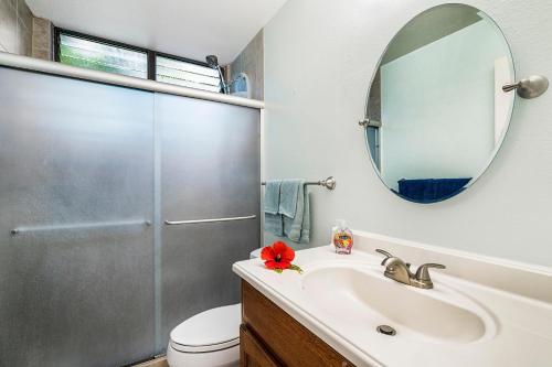 a bathroom with a sink and a shower with a mirror at Keauhou Kona Surf & Racquet Club #6-104 in Kailua-Kona