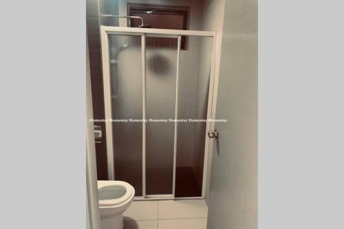 a bathroom with a toilet and a shower stall at Cosy Studio Netflix SelfCheckIn Cyberjaya 3 in Cyberjaya