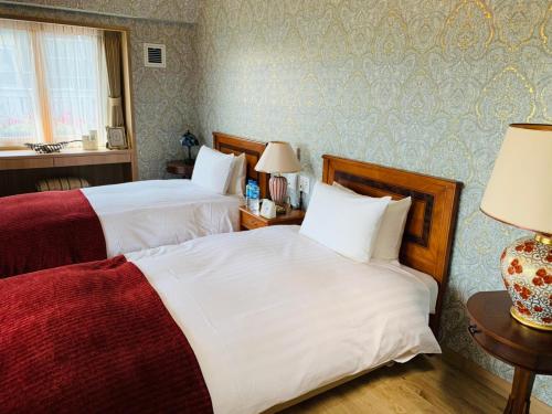 Ein Bett oder Betten in einem Zimmer der Unterkunft Auberge フレンチの森