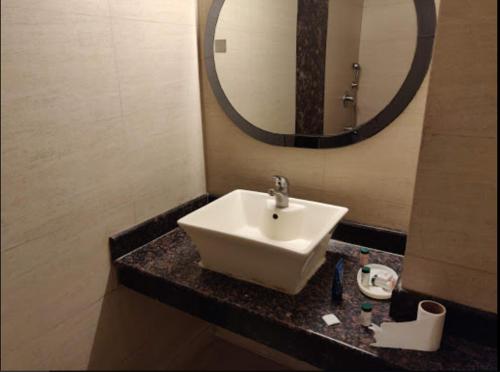 a bathroom with a white sink and a mirror at Hotel SHIMLA HERITAGE- Near B L K Hospital in New Delhi
