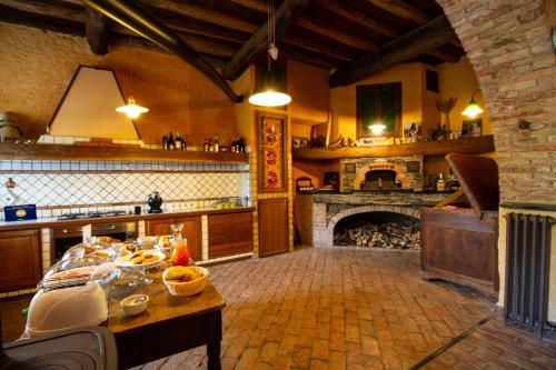 a kitchen with a fireplace and a table with food at Rivarola al Tempo Dei Castelli in Carasco