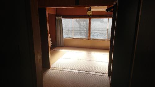 an open door to a room with a window at Guesthouse Kumano in Tanabe