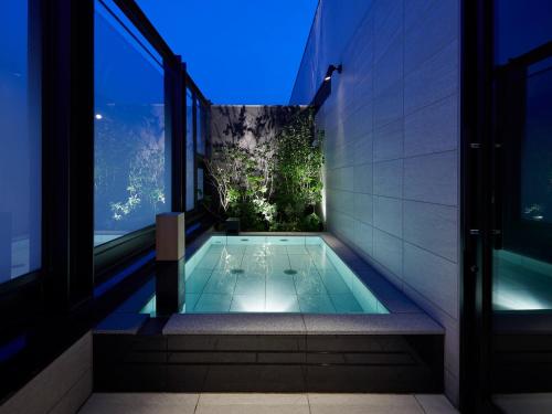 a swimming pool in the middle of a house at Susukino Granbell Hotel in Sapporo