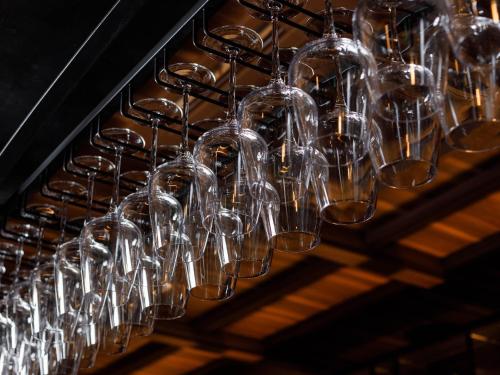 a bunch of wine glasses hanging from a rack at Susukino Granbell Hotel in Sapporo