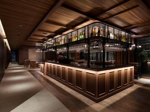 a bar with many glasses on the wall at Susukino Granbell Hotel in Sapporo