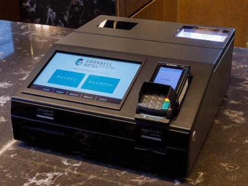 an electronic device with a cell phone on a table at Susukino Granbell Hotel in Sapporo