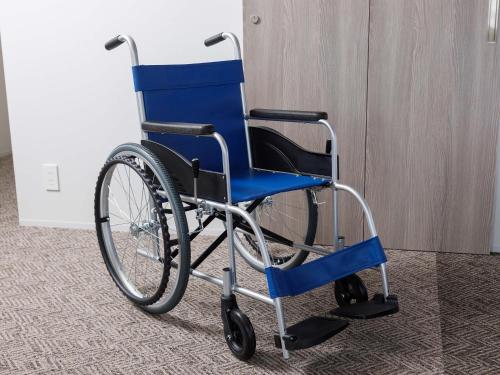 a blue wheelchair sitting in a room at Susukino Granbell Hotel in Sapporo