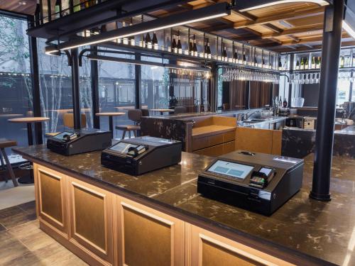 a bar in a restaurant with a counter top at Susukino Granbell Hotel in Sapporo
