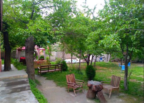 a park with benches and trees and a playground at Northern Sapphire in Hunza