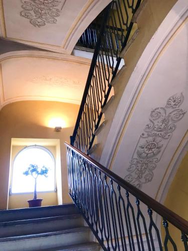 a spiral staircase in a building with a window at ANTICA FILANDA Lattes in Cuneo