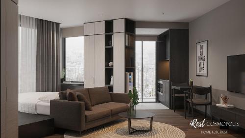 a living room with a couch and a bed at iRest COSMOPOLIS Vinh Yen in Yen