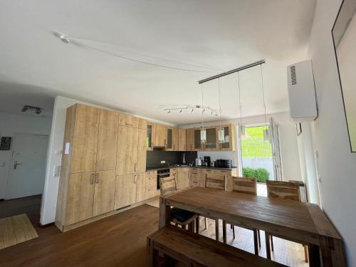 a kitchen with wooden cabinets and a wooden table at Ferienwohnung Seeblick in Pleinfeld