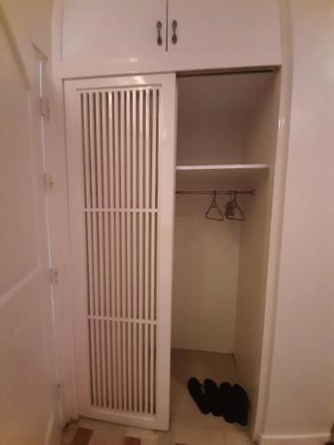 a walk in closet with a white door and some shoes at RedDoorz at Balatas Magsaysay Road Naga City in Naga