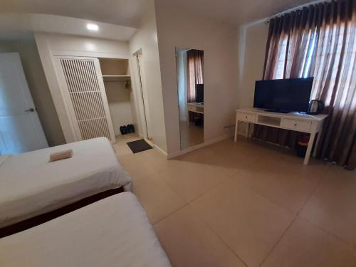 a hotel room with a bed and a television at Reddoorz @ Balatas Magsaysay Road Naga City in Naga