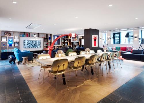 a dining room with a long table and chairs at citizenM Paris Champs-Élysées in Paris