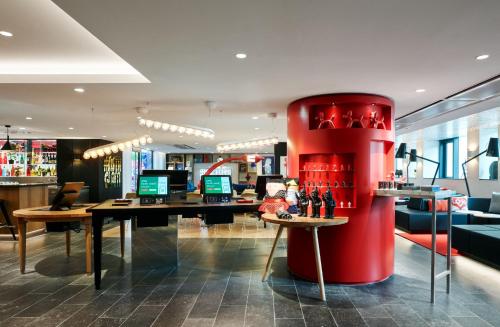 a store with a red column in the middle of a room at citizenM Paris Champs-Élysées in Paris