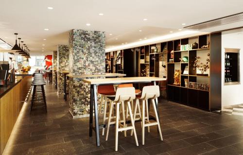 a bar in a restaurant with stools at citizenM Paris Champs-Élysées in Paris