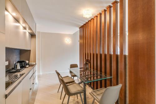 a kitchen and dining room with a table and chairs at Oriana Homèl Udine in Udine