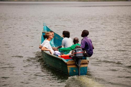 a group of people on a boat in the water at Bunyonyi Overland Resort in Kabale