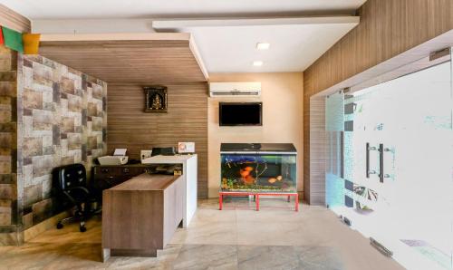 an office with a fish tank in a room at Treebo Concerto Residentia in Durgāpur