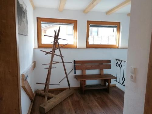 a room with a windmill and a wooden bench at Appartements Wolfgang Auderer in Jerzens