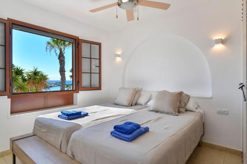 a bedroom with a large bed with blue towels on it at Puerto Chico 2 in Playa Blanca