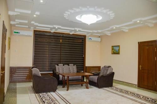 a waiting room with chairs and a table and a window at Euro Asia Hotel in Samarkand