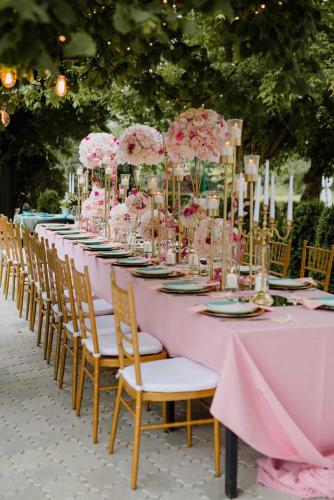 a long pink table with chairs and flowers on it at Kod Brke in Veliko Gradište