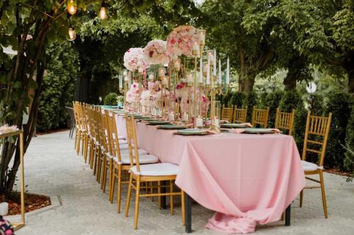 a long table with chairs and pink flowers on it at Kod Brke in Veliko Gradište