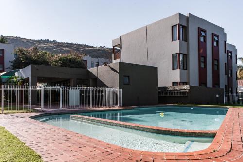 a swimming pool in front of a building at Bedfordview Haven in Johannesburg