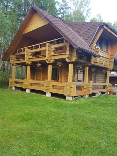 ein großes Holzhaus mit einem Gamer-Dach in der Unterkunft Guļbūve ar saunu, kamīnu in Saulkrasti