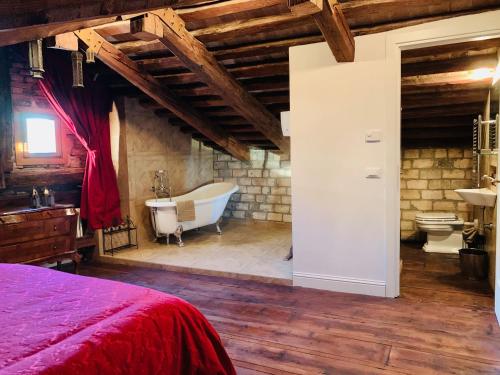 a bedroom with a bed and a tub and a sink at Ca Dode Grand Canal in Venice
