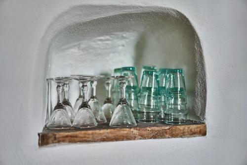 a shelf with glass vases on a wall at Casa Carlazzo in Carlazzo