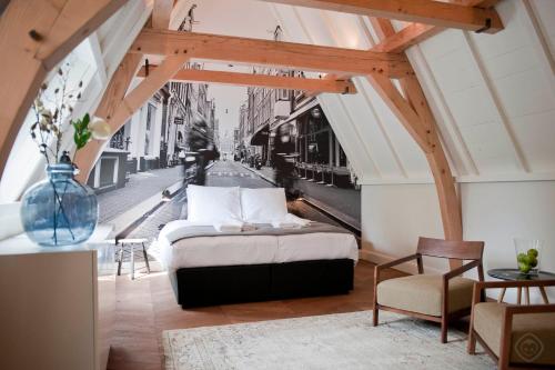 a bedroom with a bed with a view of a street at Hotel IX Nine Streets Amsterdam in Amsterdam