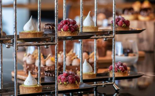 a display of muffins and desserts on a shelf at Hyatt Regency Taghazout in Taghazout