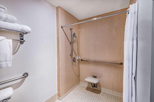 a bathroom with a shower and a toilet at Wyndham Garden San Diego in San Diego