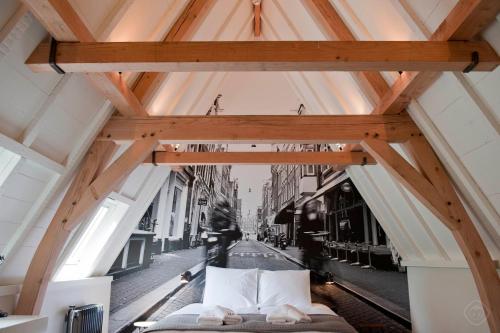 a bed in a room with a view of a street at Hotel IX Nine Streets Amsterdam in Amsterdam