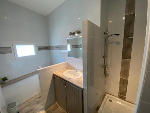 a bathroom with a sink and a shower at Le Mazet du Petit Chemin in Caux