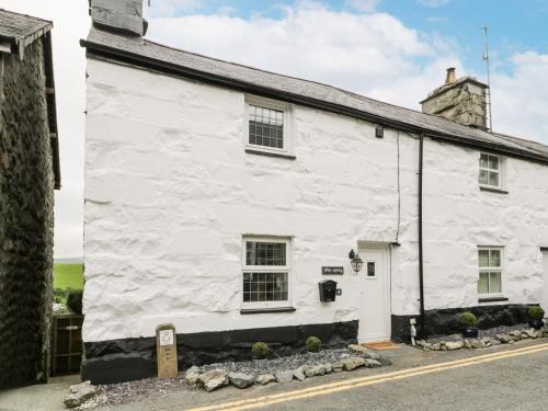 an old white building with a sign in front of it at Plas Arenig in Blaenau-Ffestiniog