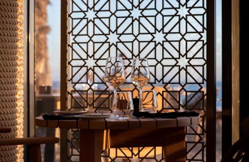 a table with wine glasses on top of it at Hyatt Regency Taghazout in Taghazout
