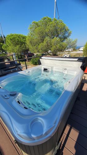 a hot tub sitting on top of a building at Floating Sea House SONČEK in Portorož