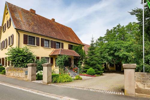 a large yellow house with a roof at Ferienwohnung Nesselbachtal in Neustadt an der Aisch