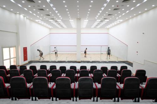 an auditorium with black chairs and a basketball court at Tolip Gardens Hotel in Cairo