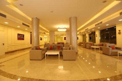 a lobby with couches and tables in a building at Gloria Aqua Park Hotel in Aswan