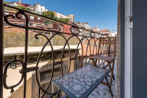 a balcony with two chairs on a balcony at GuestReady - Miragaia Rooftop in Porto