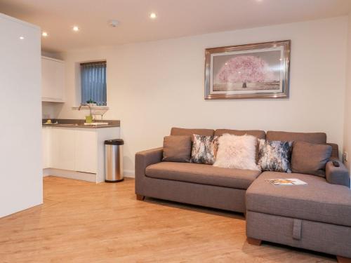 a living room with a couch and a kitchen at ViewLangho in Blackburn