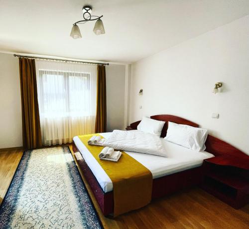 Postel nebo postele na pokoji v ubytování Vila Simina
