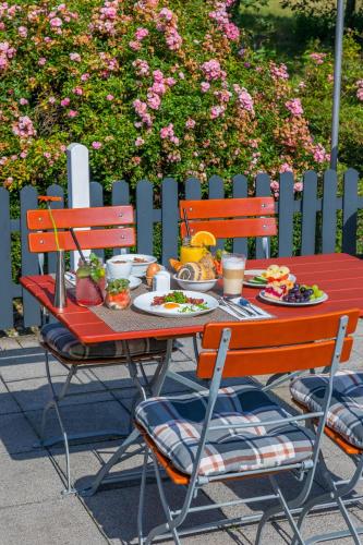a red table with food on it next to a fence at Hotel Oberhausen Neue Mitte affiliated by Meliá in Oberhausen