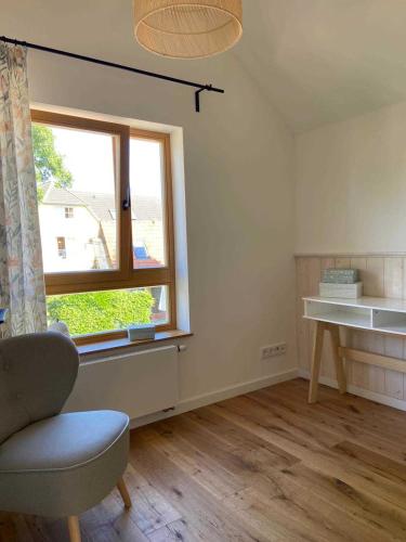 a room with a window and a chair and a desk at Ferienhaus angelangt Prerow in Prerow