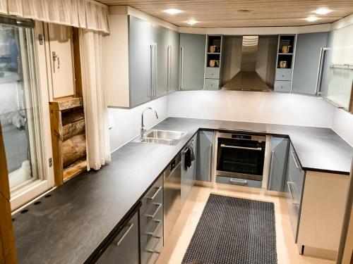 a kitchen with stainless steel cabinets and a sink at Villa Valtavaara in Ruka